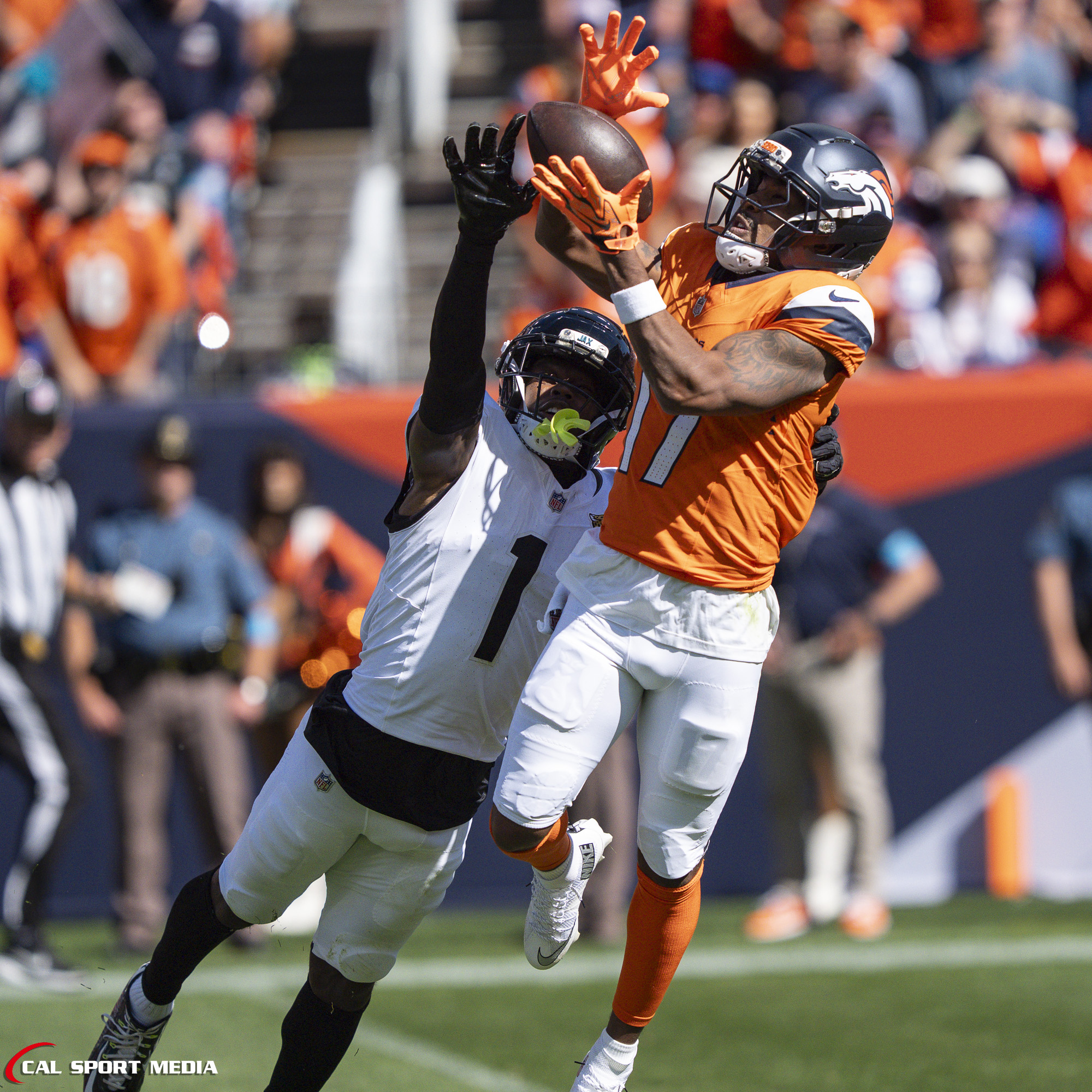 Sep 20, 2026; Denver Broncos wide receiver Jaylen Waddle (17) makes a 49-yard catch over Jacksonville Jaguars cornerback Montaric Brown (1) during the game between the Denver Broncos and Jacksonville Jaguars in Denver, CO, USA; at Empower Field at Mile High. Mandatory Credit: Derek Regensburger-Cal Sport Media